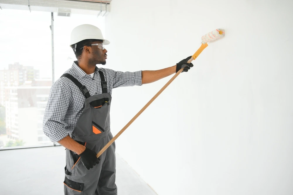 Painting Services Man Painting a wall