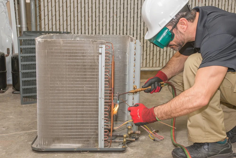 AC Repair man welding Air conditioner