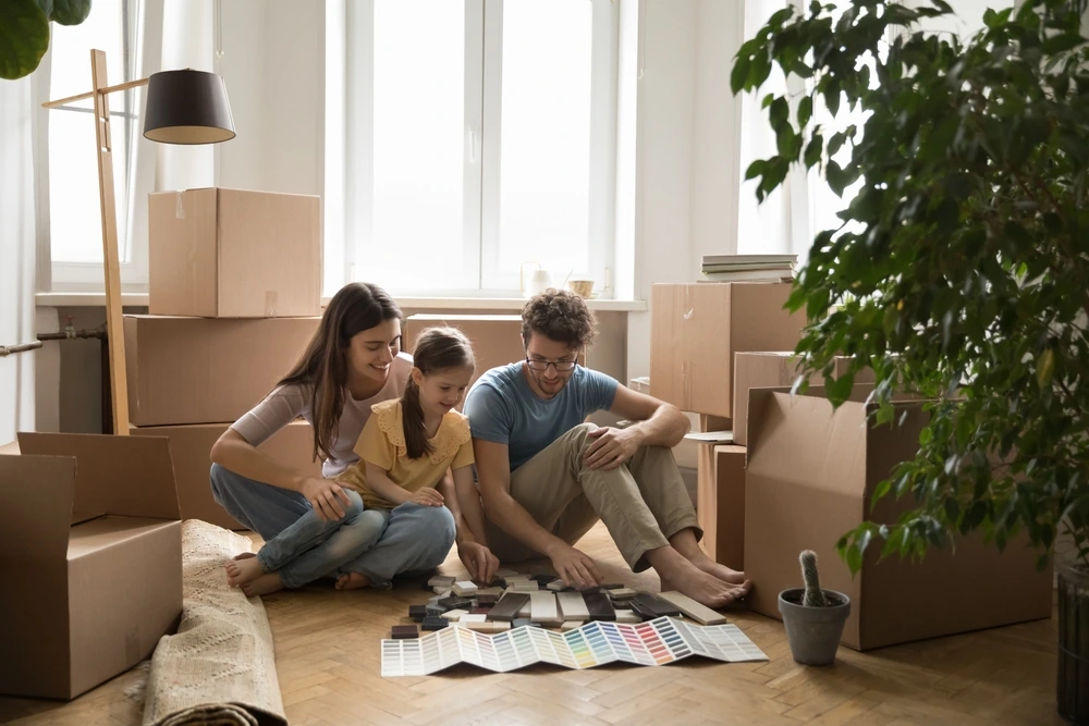 happy family sitting on Parquet Floor