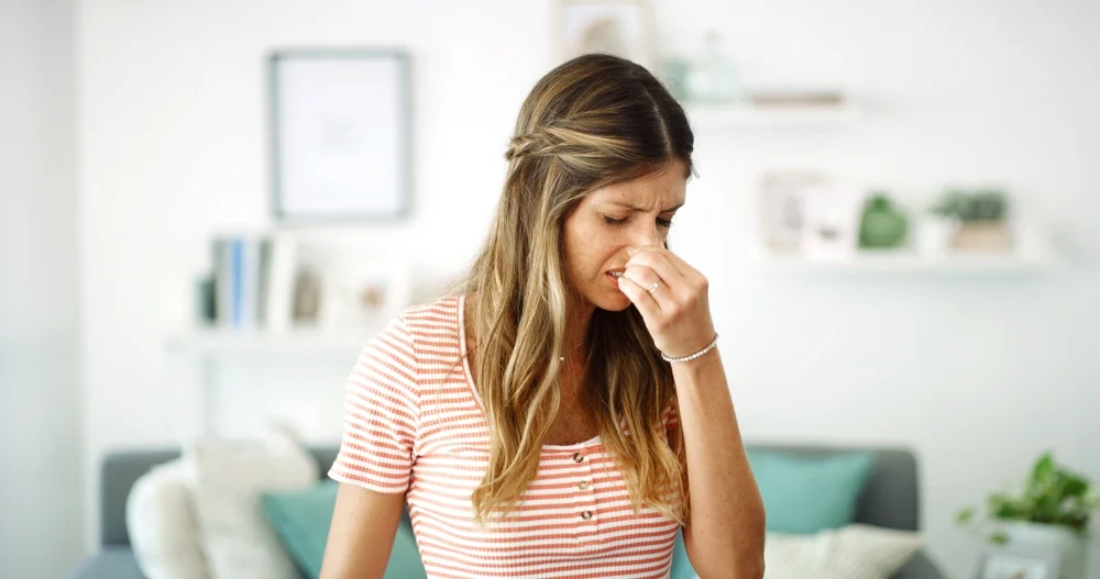 bad smell lady holding nose